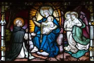 Glassmaleri av St. Dominikus som får rosenkransen fra Jomfru Maria